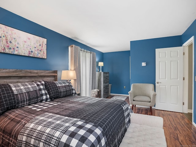 bedroom featuring baseboards and wood finished floors