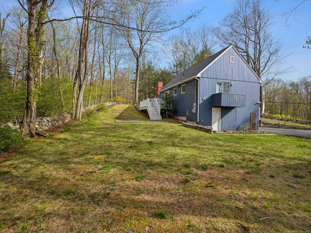 view of yard featuring a wooden deck and stairs