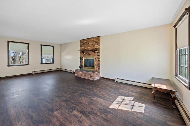 unfurnished living room with a baseboard heating unit and wood finished floors