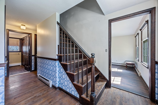 staircase featuring baseboards, baseboard heating, and wood finished floors