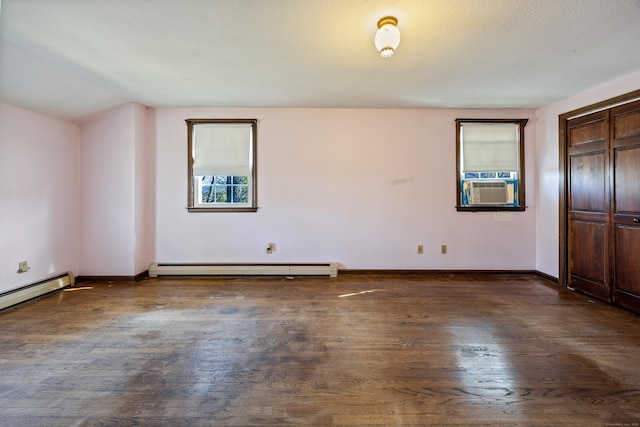 unfurnished bedroom featuring baseboards, a baseboard radiator, cooling unit, and wood finished floors