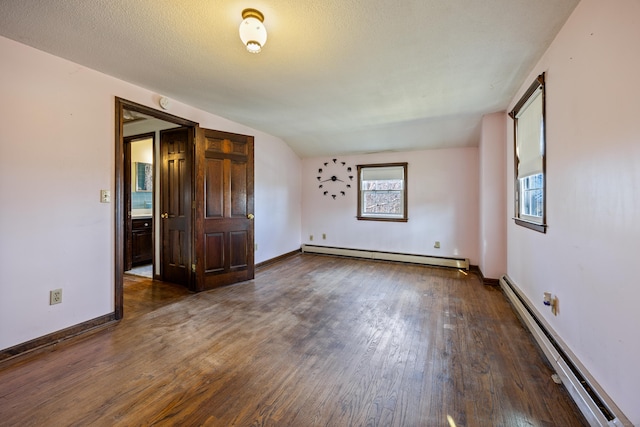 unfurnished room with wood finished floors, baseboards, baseboard heating, and a baseboard radiator