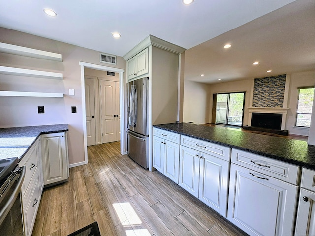 664C Heritage Vlg, Southbury, CT 06488 - kitchen with stainless steel fridge with ice dispenser, range, open shelves, recessed lighting, and light wood finished floors