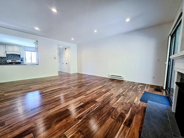 664C Heritage Vlg, Southbury, CT 06488 - unfurnished living room featuring dark wood finished floors, a fireplace with flush hearth, recessed lighting, and baseboard heating