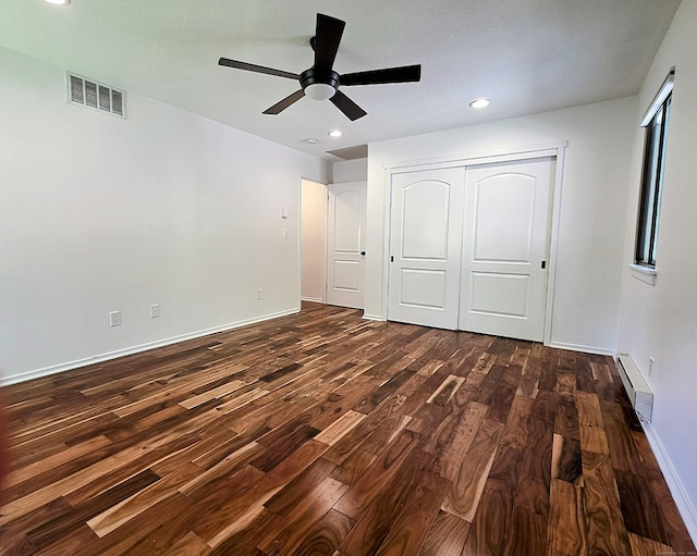 664C Heritage Vlg, Southbury, CT 06488 - unfurnished bedroom featuring a baseboard heating unit, dark wood-type flooring, a closet, baseboards, and recessed lighting