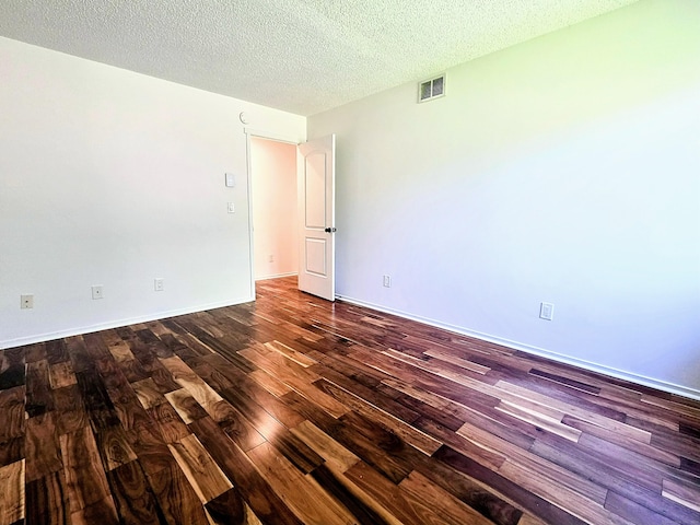 664C Heritage Vlg, Southbury, CT 06488 - unfurnished room featuring dark wood-style floors and a textured ceiling
