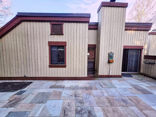 664C Heritage Vlg, Southbury, CT 06488 - rear view of house featuring a chimney and a patio