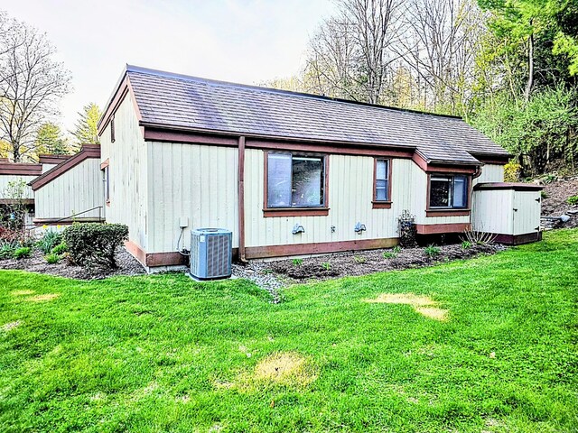664C Heritage Vlg, Southbury, CT 06488 - rear view of house with central air condition unit, a yard, and a shingled roof