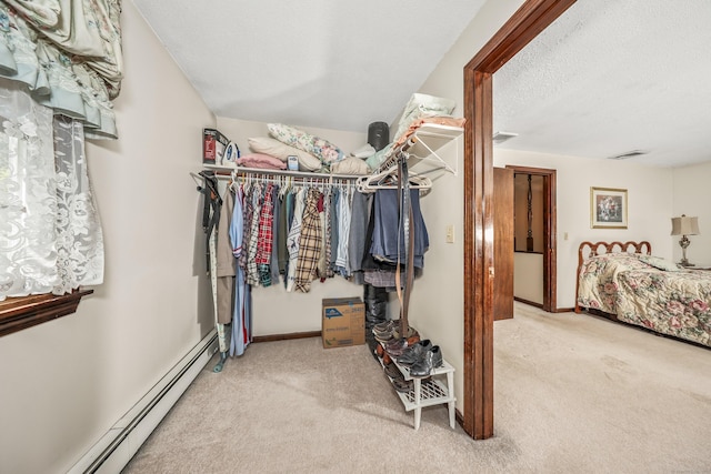 walk in closet with visible vents, carpet flooring, and baseboard heating