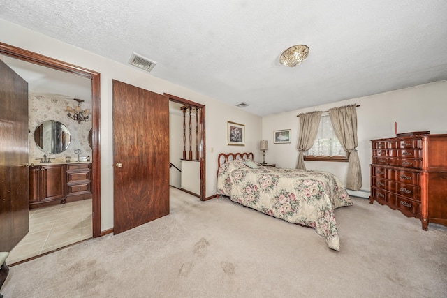 carpeted bedroom with visible vents, a textured ceiling, baseboards, and baseboard heating