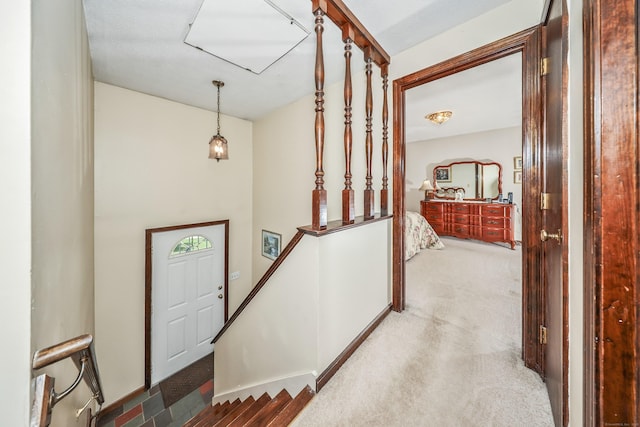 hall featuring carpet flooring and an upstairs landing