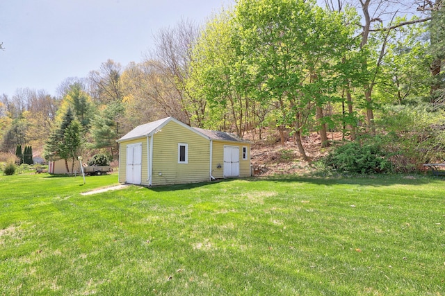 view of yard with a storage unit and an outbuilding