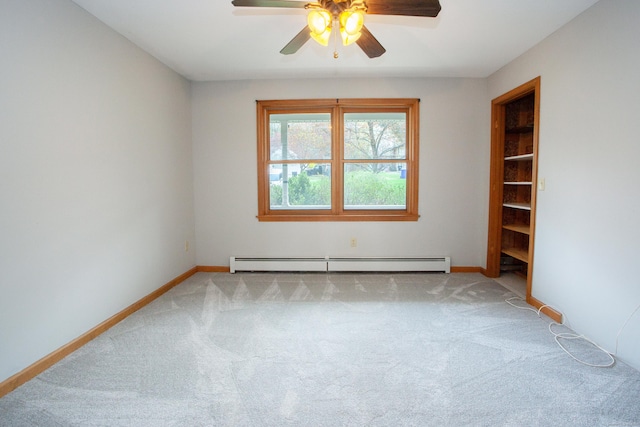 empty room with a ceiling fan, baseboard heating, carpet, and baseboards