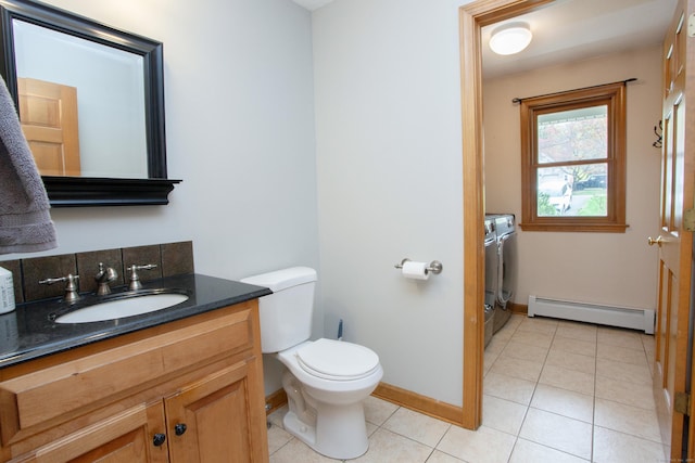 bathroom with a baseboard radiator, baseboards, toilet, vanity, and tile patterned flooring