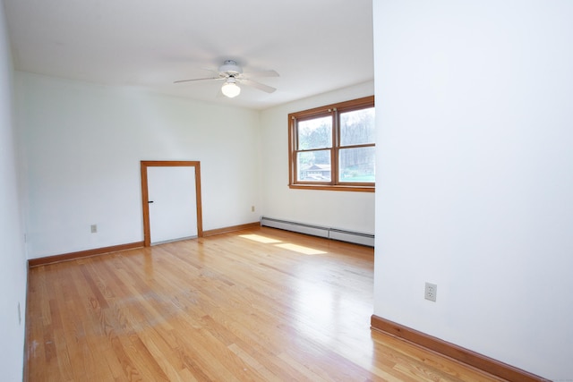 unfurnished room with a ceiling fan, light wood-style flooring, a baseboard heating unit, and baseboards