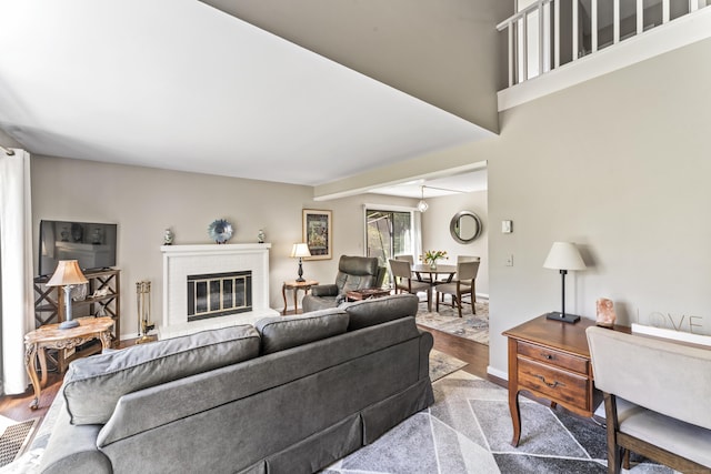 331 Heritage Vlg Unit E, Southbury, CT 06488 - living room with wood finished floors, a brick fireplace, baseboards, and beam ceiling