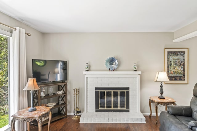 331 Heritage Vlg Unit E, Southbury, CT 06488 - living room featuring a fireplace, wood finished floors, and baseboards