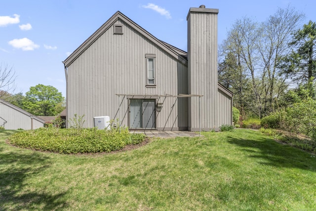 331 Heritage Vlg Unit E, Southbury, CT 06488 - back of property featuring a yard, a chimney, a barn, and an outdoor structure