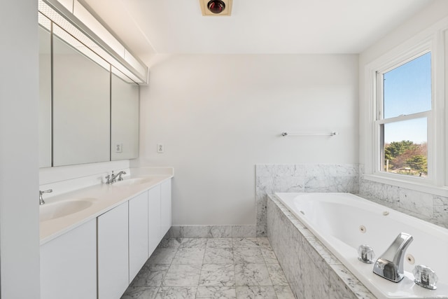 43 Harbor Dr Apt 312, Stamford, CT 06902 - bathroom with marble look tiles, double vanity, a tub with jets, and baseboards