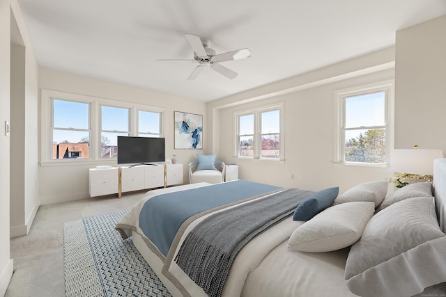 43 Harbor Dr Apt 312, Stamford, CT 06902 - bedroom with multiple windows, light carpet, baseboards, and a ceiling fan