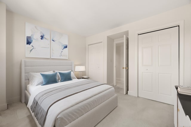 43 Harbor Dr Apt 312, Stamford, CT 06902 - bedroom featuring light colored carpet, two closets, and baseboards