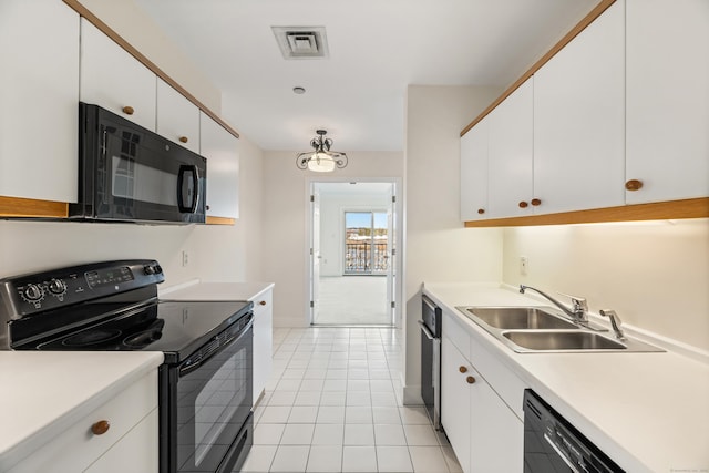 43 Harbor Dr Apt 312, Stamford, CT 06902 - kitchen with black appliances, a sink, white cabinets, and light countertops