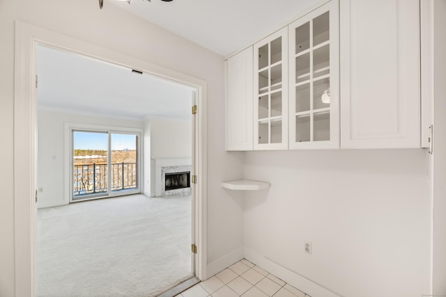 43 Harbor Dr Apt 312, Stamford, CT 06902 - unfurnished dining area featuring a high end fireplace, baseboards, and light carpet