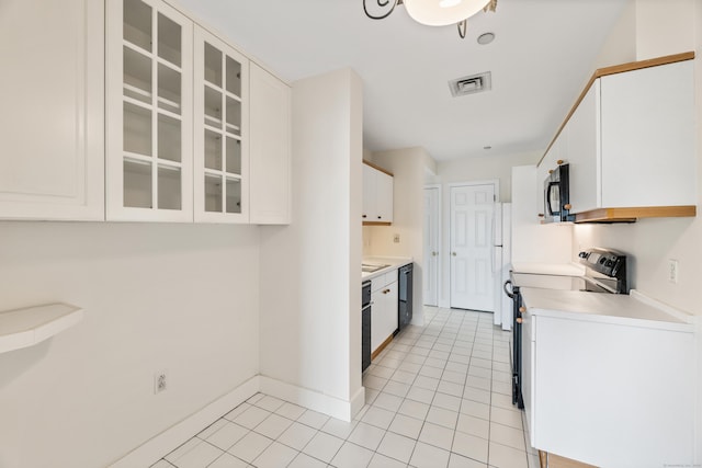 43 Harbor Dr Apt 312, Stamford, CT 06902 - kitchen featuring black appliances, white cabinetry, light tile patterned flooring, and glass insert cabinets