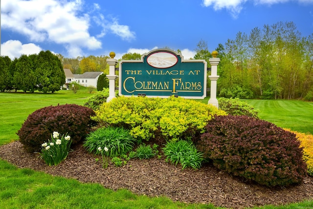 community / neighborhood sign with a yard