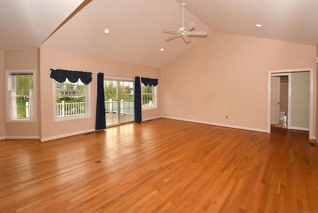 unfurnished living room featuring light wood-type flooring, a ceiling fan, baseboards, and high vaulted ceiling