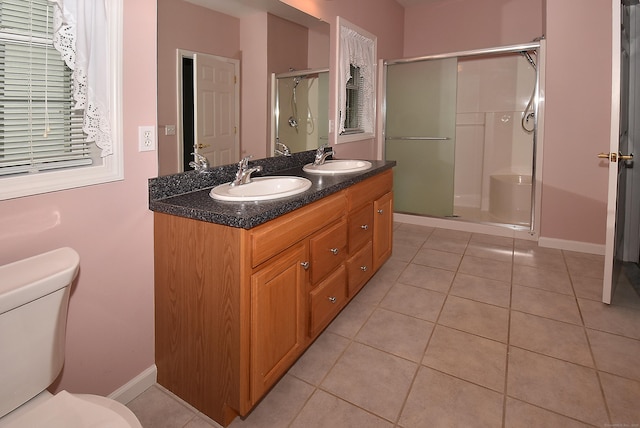 full bathroom featuring a sink, tile patterned flooring, a shower stall, and toilet