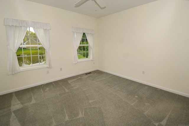 carpeted empty room with baseboards and ceiling fan