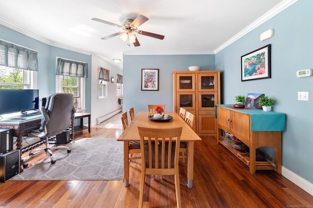 dining room with crown molding, a baseboard radiator, a ceiling fan, and wood finished floors