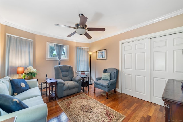living area featuring wood-type flooring, ceiling fan, and ornamental molding
