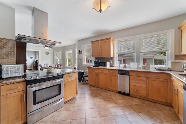 kitchen with light tile patterned floors, appliances with stainless steel finishes, range hood, and backsplash