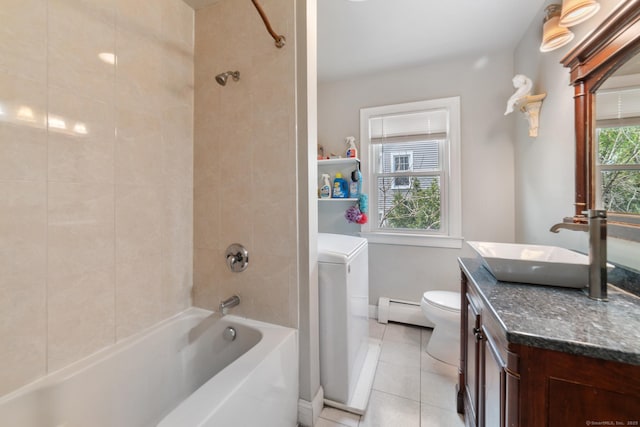 bathroom featuring baseboard heating, tile patterned floors, vanity, toilet, and washer / dryer