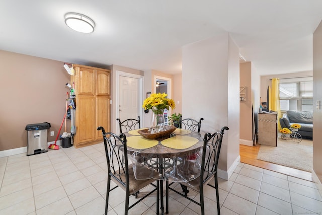 dining area with baseboards and light tile patterned flooring