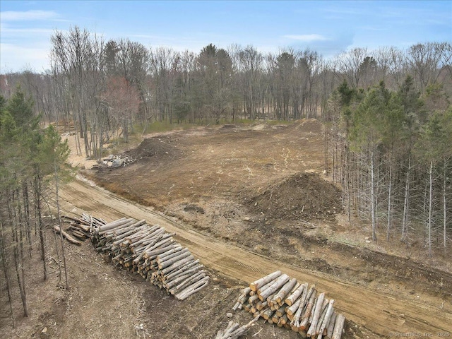 exterior space featuring a wooded view