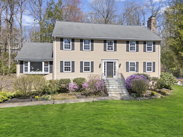 18 Hammersmith, Avon, CT 06001 - colonial-style house featuring roof with shingles, a chimney, and a front yard