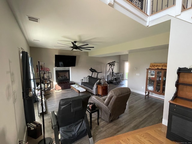 16 Catherine Dr, Wolcott, CT 06716 - living room with visible vents, wood finished floors, baseboards, a fireplace with raised hearth, and a ceiling fan