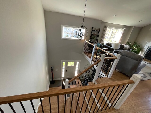 16 Catherine Dr, Wolcott, CT 06716 - staircase featuring an inviting chandelier, baseboards, plenty of natural light, and wood finished floors