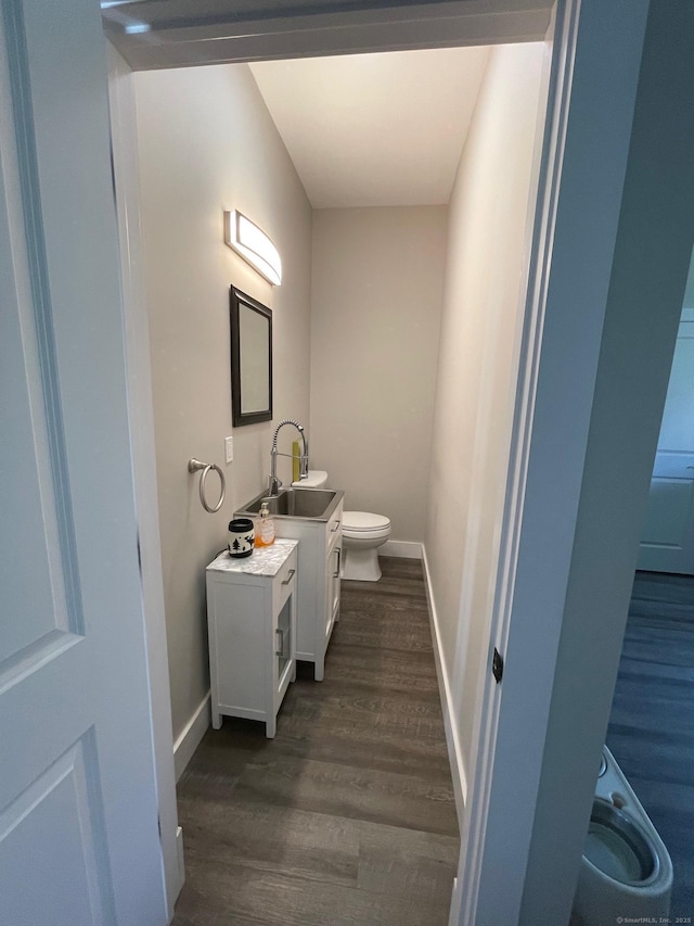 16 Catherine Dr, Wolcott, CT 06716 - half bath featuring vanity, baseboards, toilet, and wood finished floors