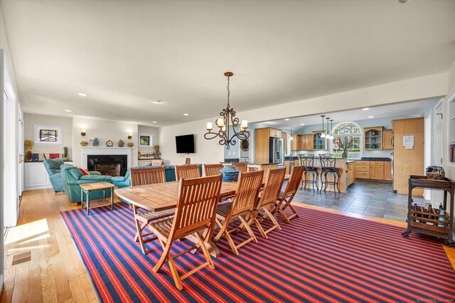 355 W Lake St, Winchester, CT 06098 - dining space with recessed lighting, an inviting chandelier, wood finished floors, and a fireplace