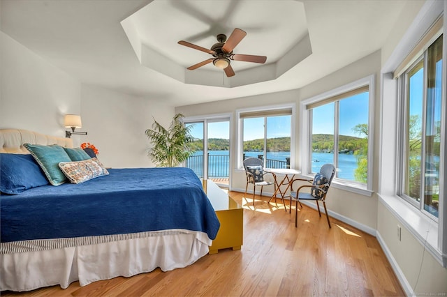 355 W Lake St, Winchester, CT 06098 - bedroom with access to outside, a raised ceiling, baseboards, wood finished floors, and a water view
