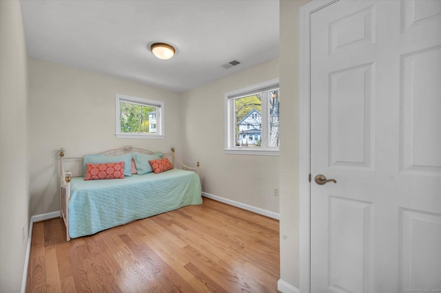 355 W Lake St, Winchester, CT 06098 - bedroom with visible vents, baseboards, wood finished floors, and multiple windows