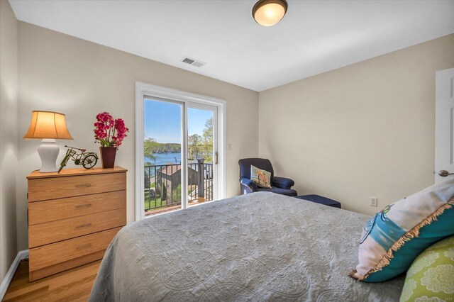 355 W Lake St, Winchester, CT 06098 - bedroom featuring access to exterior, baseboards, wood finished floors, a water view, and visible vents