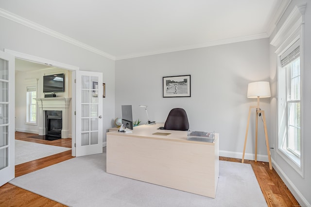 office area featuring crown molding, plenty of natural light, french doors, and wood finished floors