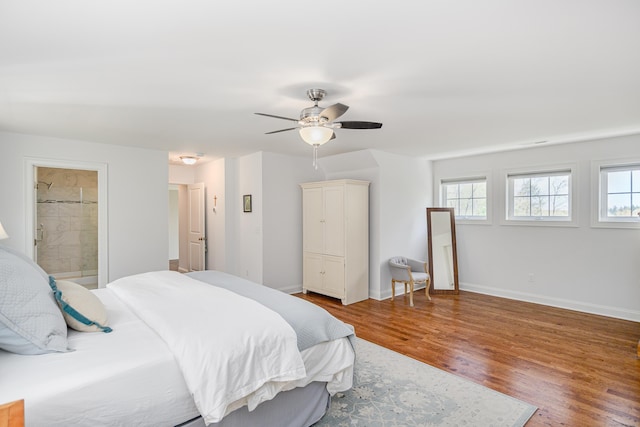 bedroom with ceiling fan, baseboards, multiple windows, and wood finished floors