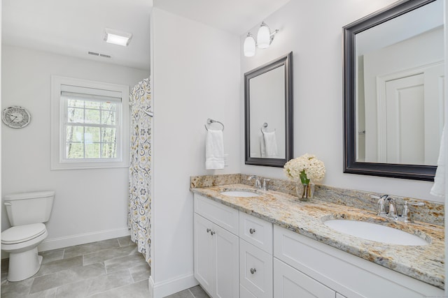 full bath featuring baseboards, a sink, visible vents, and toilet