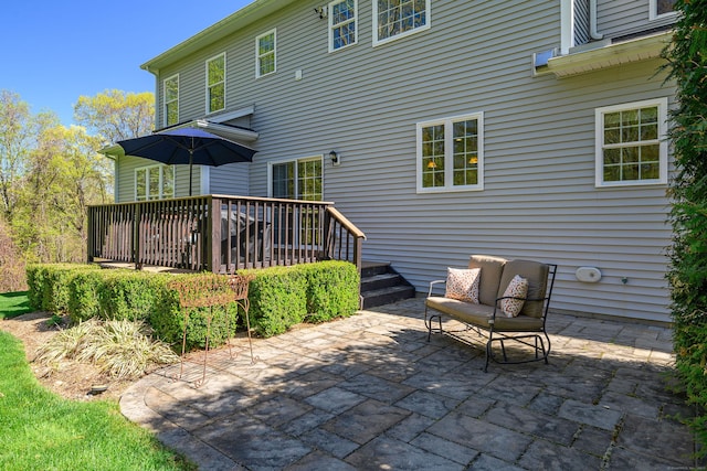 rear view of house with a patio and a wooden deck